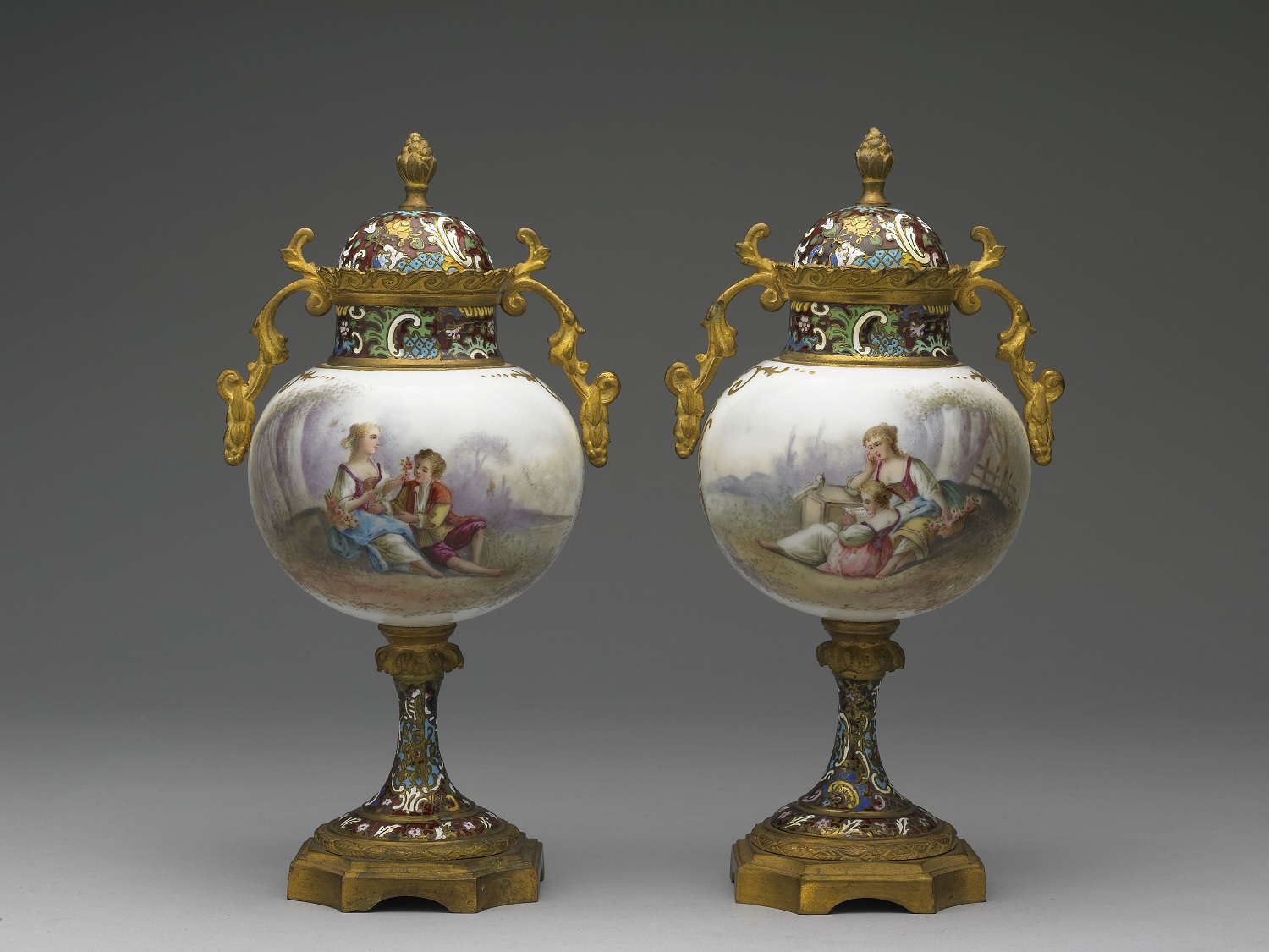 Pair of urns with painted enamel decoration of Western figures on porcelain