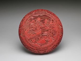 Carved red lacquer box with figures