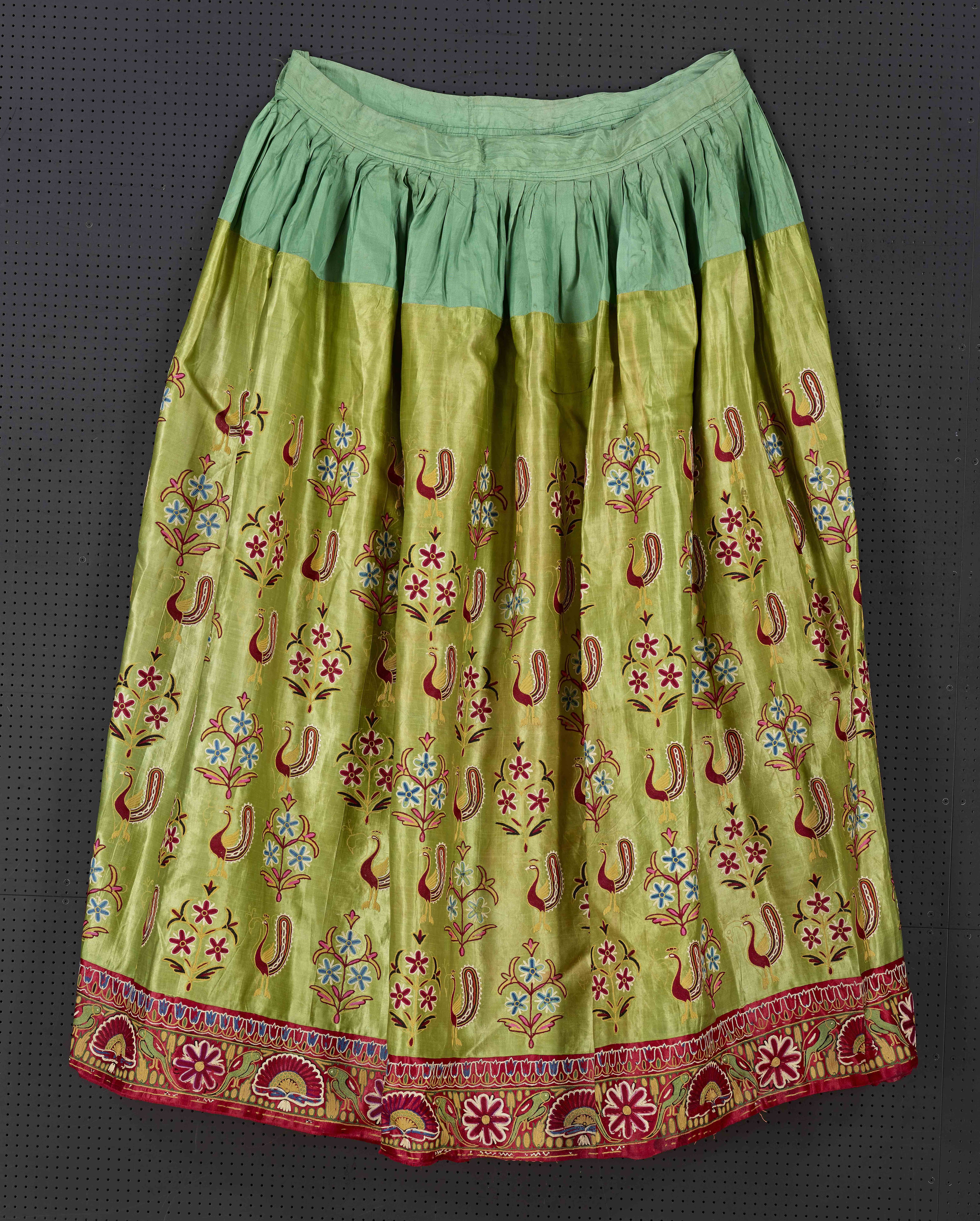 Green skirt embroidered with flowers and peacocks