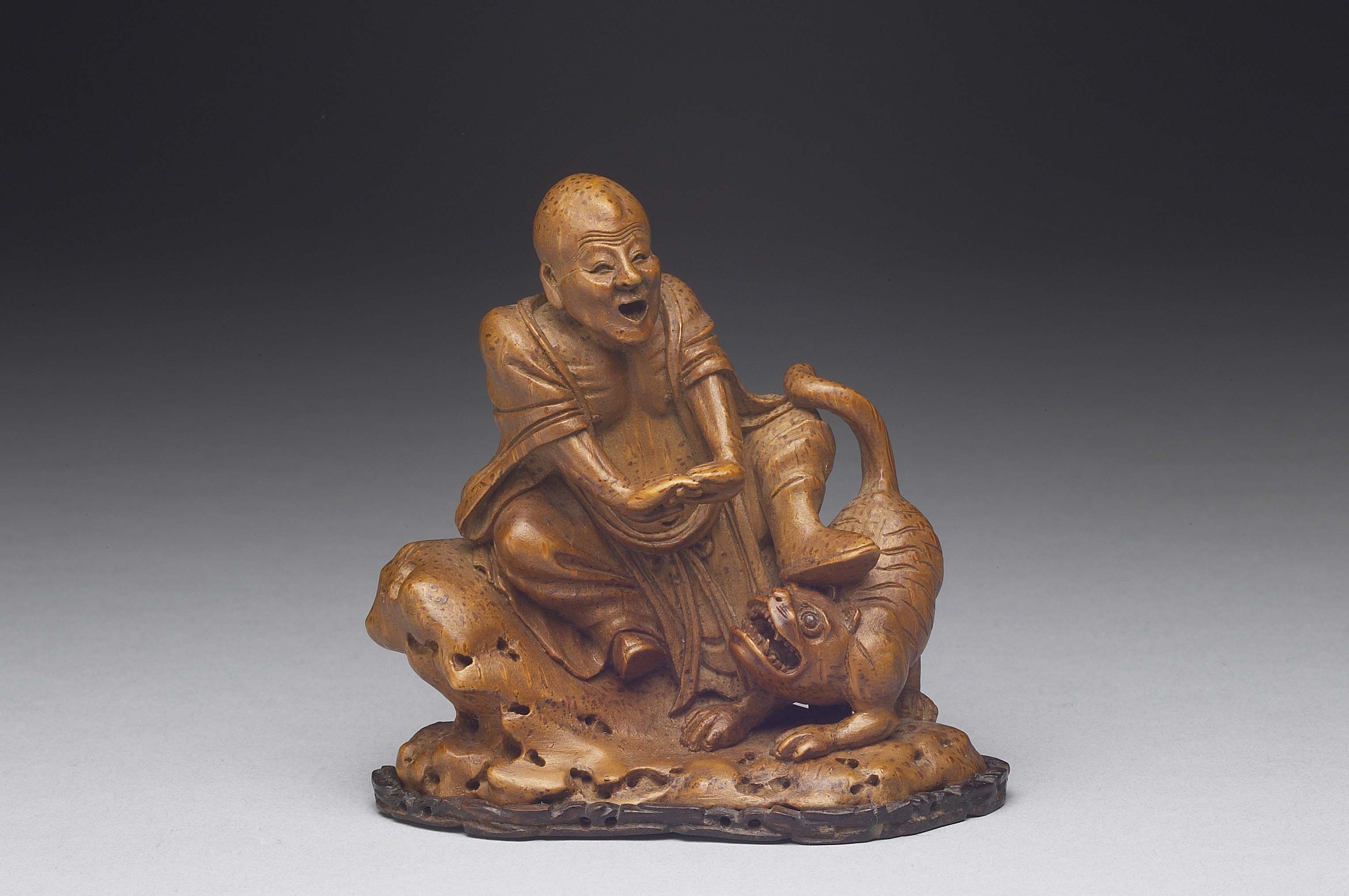 Bamboo carving of tiger-taming lohan