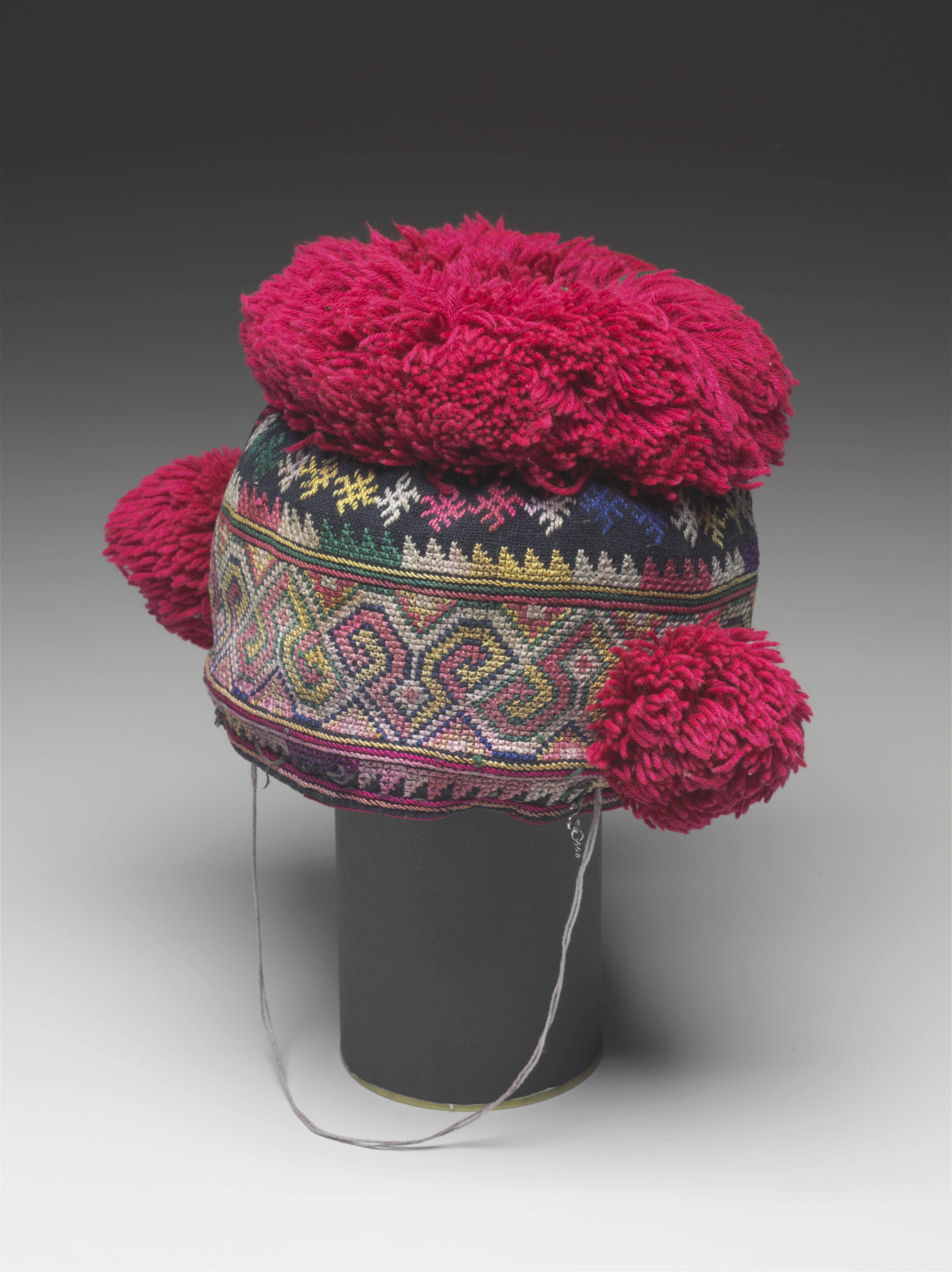 Child’s hat with embroidery and pompoms